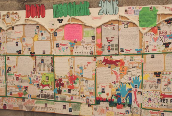 A wall in the lunchroom showcases photos and stories written by employees’ children in order to earn a stipend for school supplies.