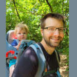 image of GPN's Forty under 40 winner Class of 2025 Jason Henry with his son in a backpack carrier