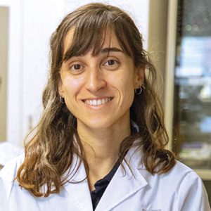 headshot of smiling woman in lab coat