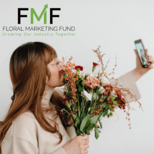 women holding flowers and a phone in the other hand trying to take a self photo