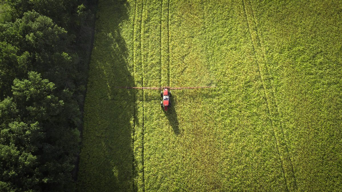An overhead view of a piece of farm equipment in a vast green field