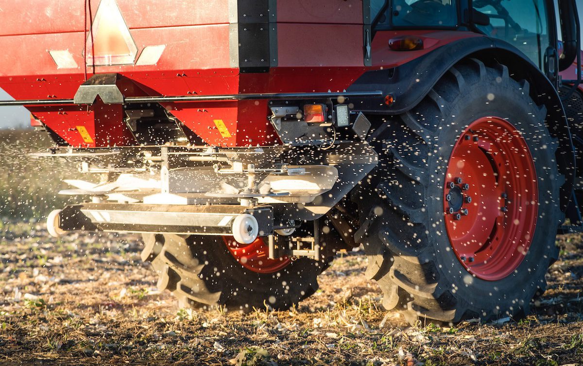 Tractor spreading artificial fertilizers. Transport, agricultural.