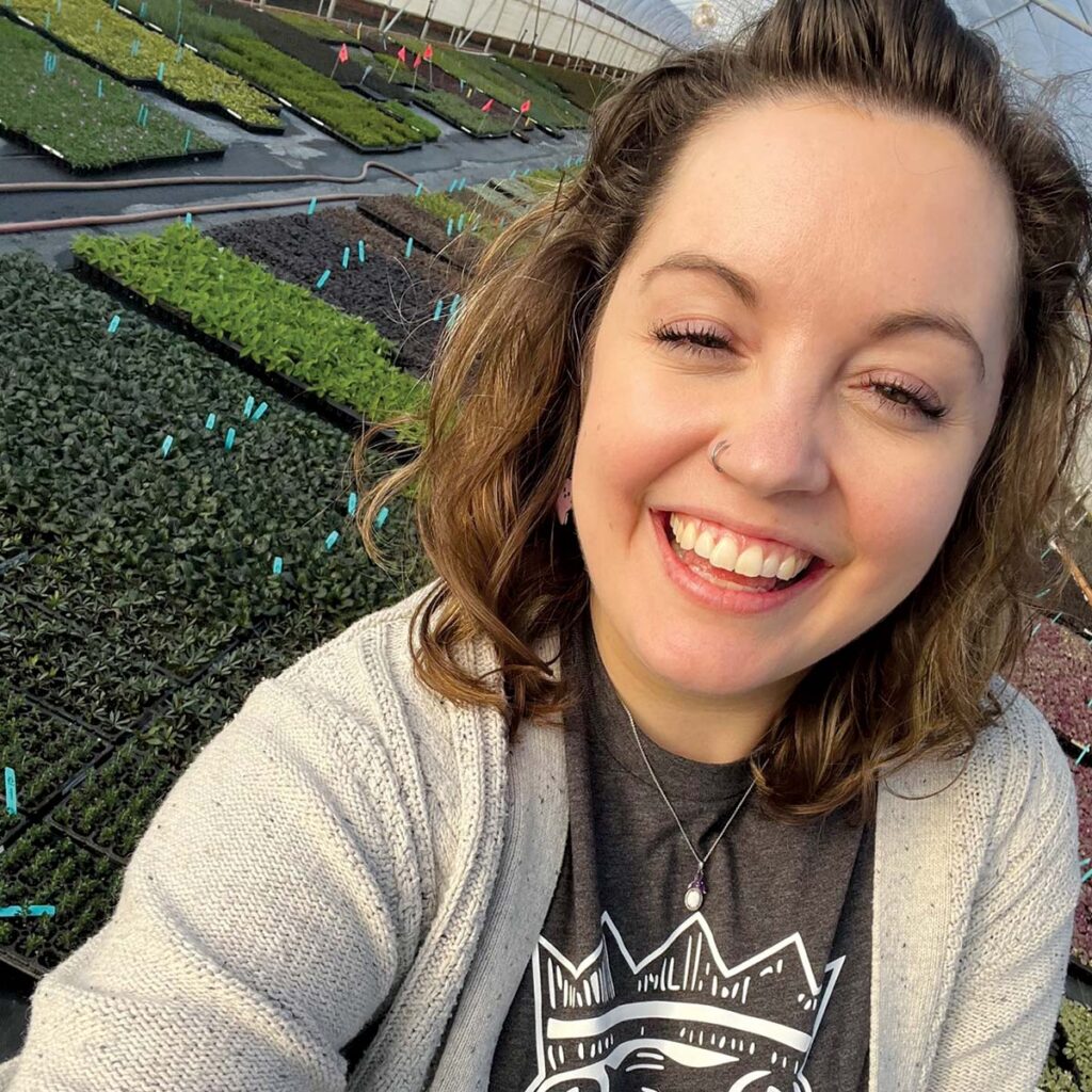 smiling woman in greenhouse
