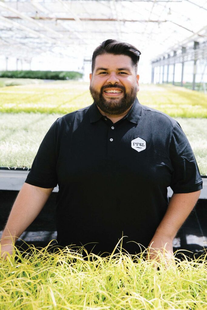 smiling man in greenhouse