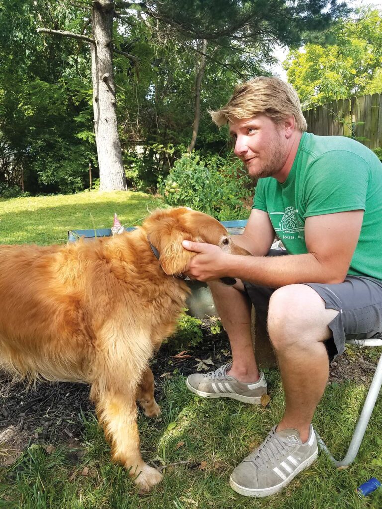 man petting dog