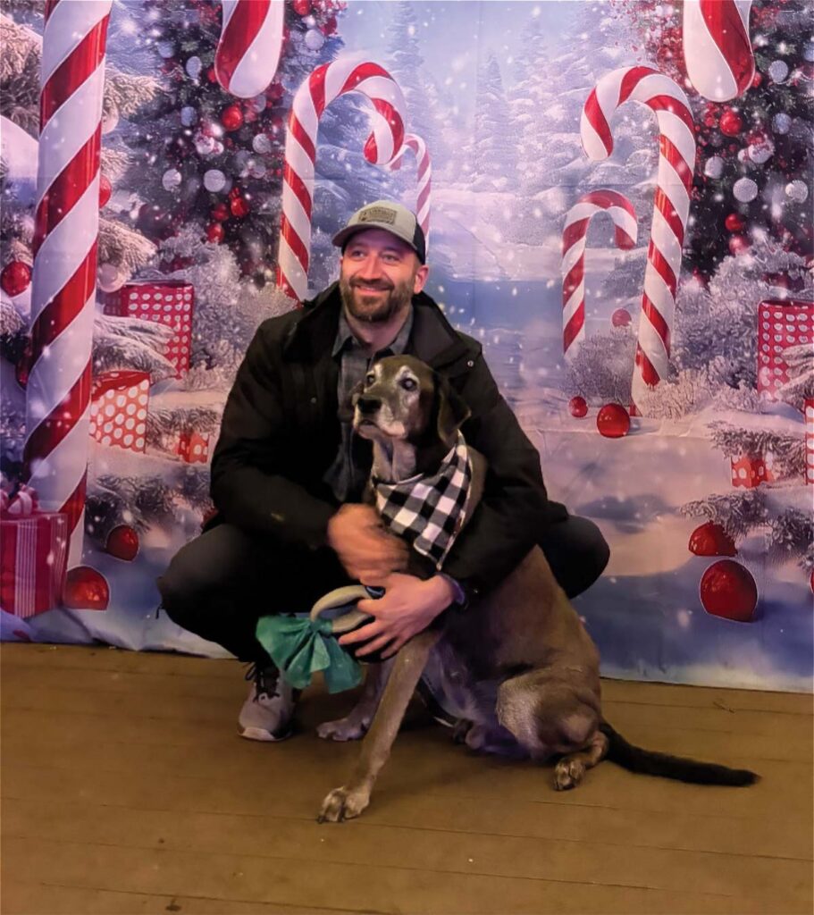 man posing with dog