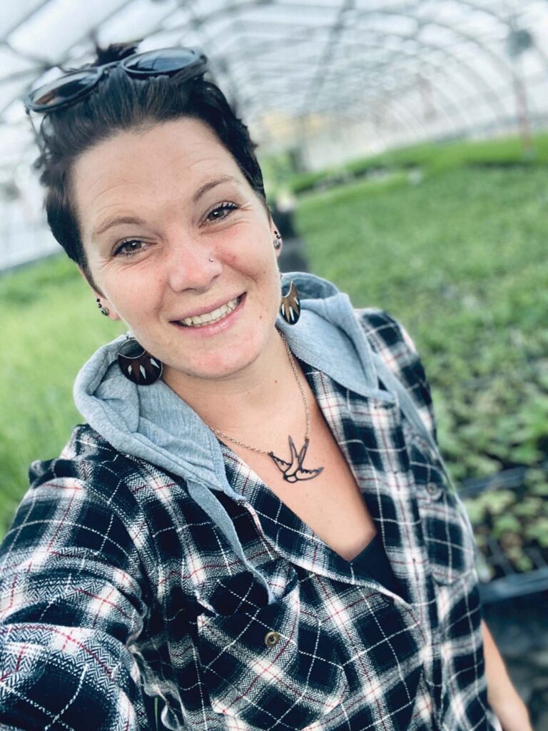 smiling woman in greenhouse
