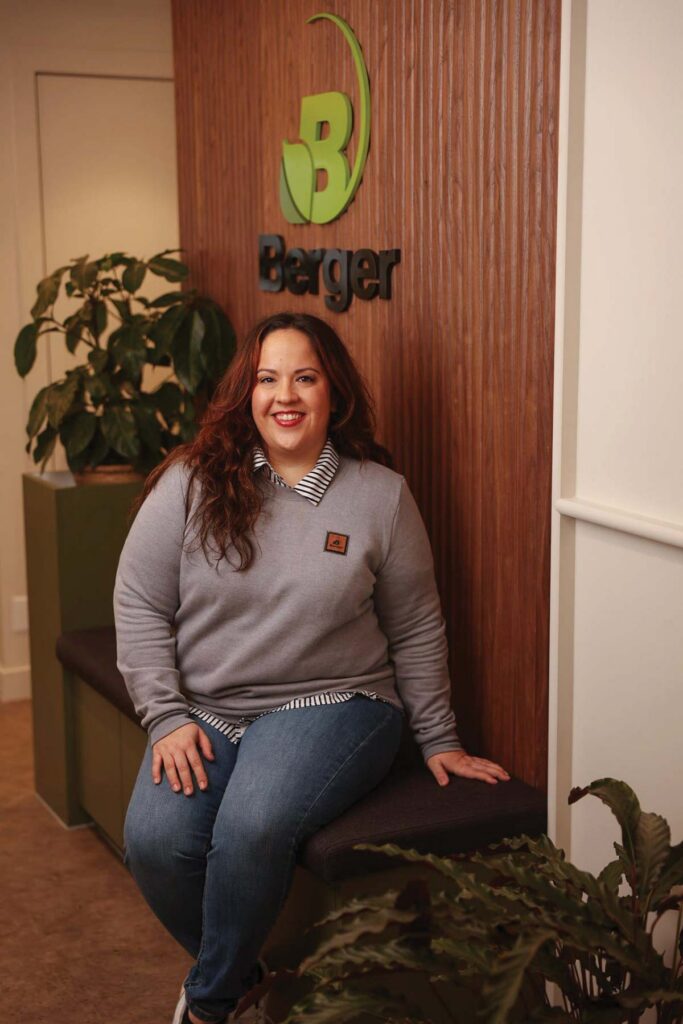 smiling woman sitting  with hand on leg